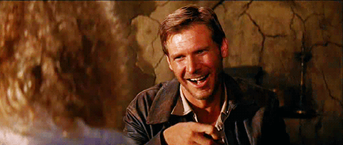Amused-Indiana-Jones-Eats-Stares-At-You.gif