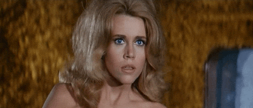 The-Beautiful-Jane-Fonda-Laughs-And-Covers-Her-Mouth-Politely-In-Barbarella.gif