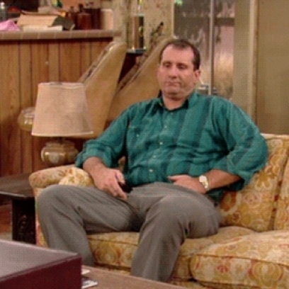 Al Bundy Bored At Home Switching The TV Channel On Married With Children.